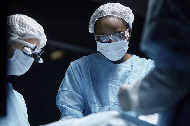 A neurosurgical team working together in theatre